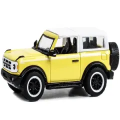 2023 Ford Bronco Heritage Ed Yellowstone Met. w/Oxford White Top "Showroom Floor" Series 3 1/64 Diecast Model Car by Greenlight