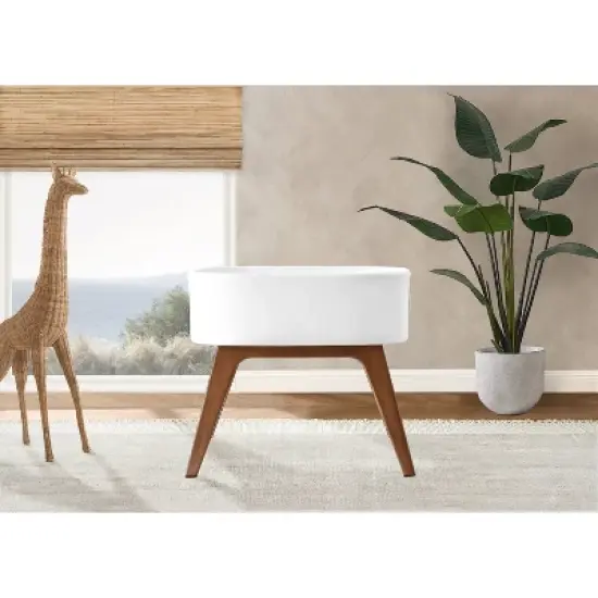 Delta Children Aero Bassinet Modern Portable Baby Crib with Solid Wood Legs, Mattress Pad and Fitted Sheet - White image {2}